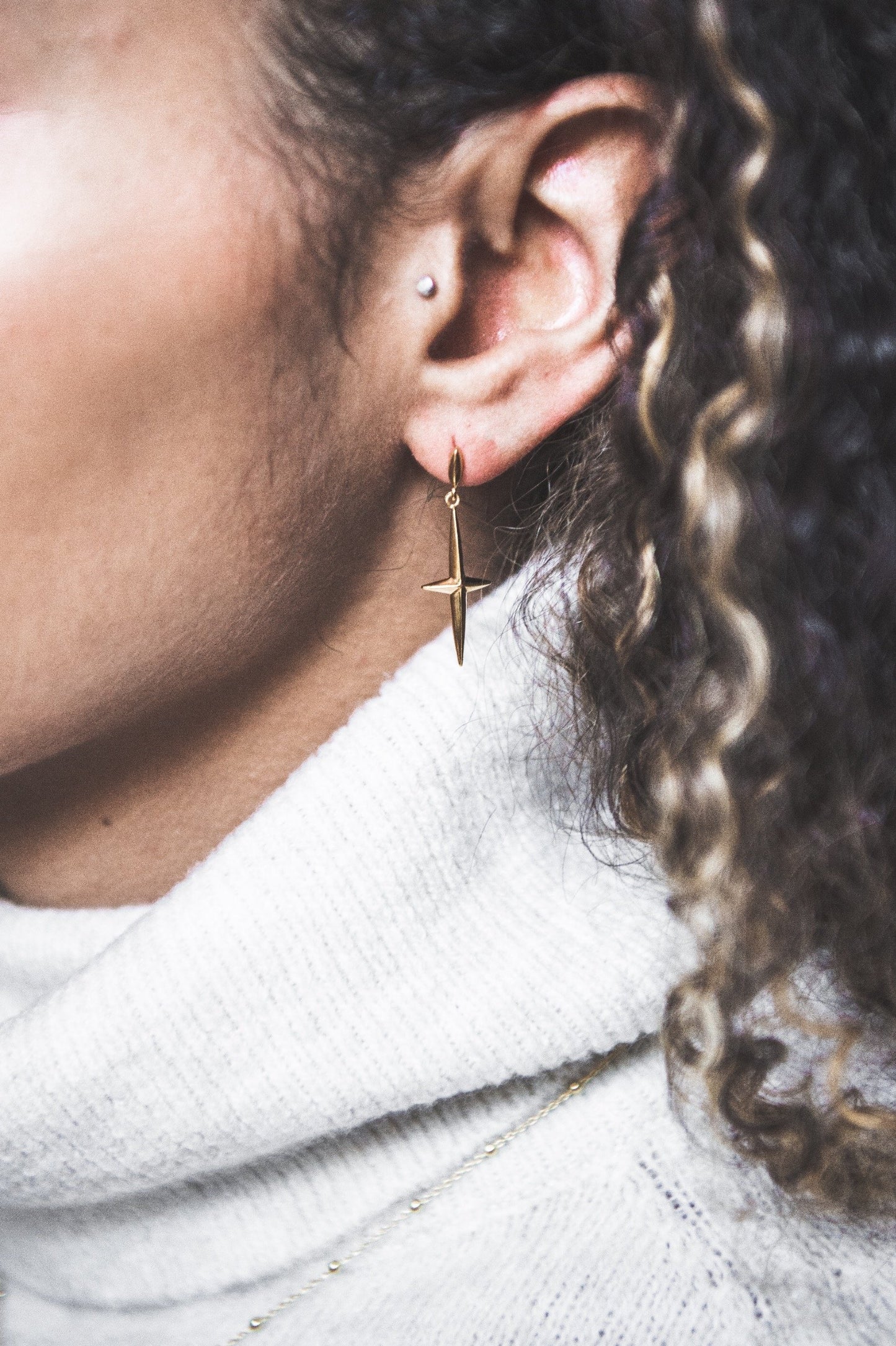 Close up of woman wearing Cross Stud