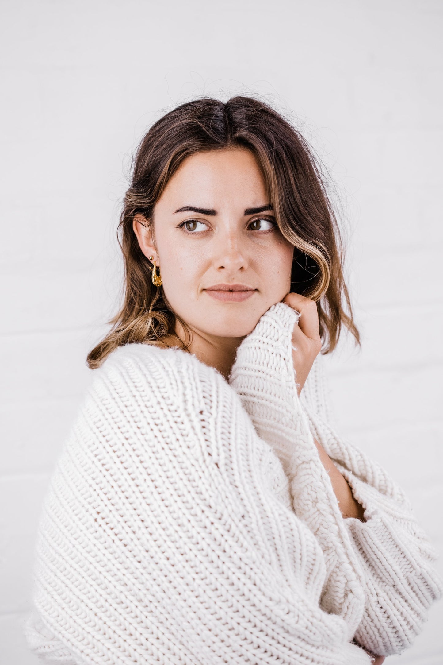 Woman wearing Ella Open Oval Hoop earring