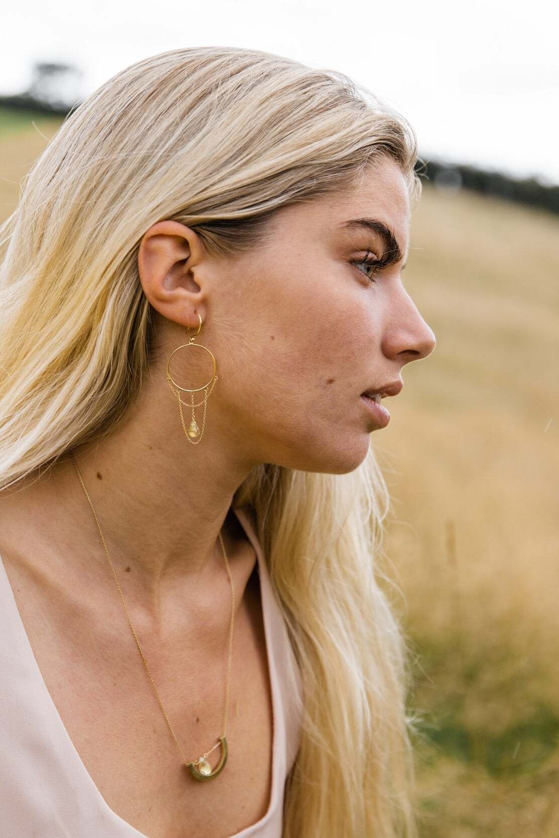 Woman wearing Guardian Chandelier Clear Quartz Drop Earring